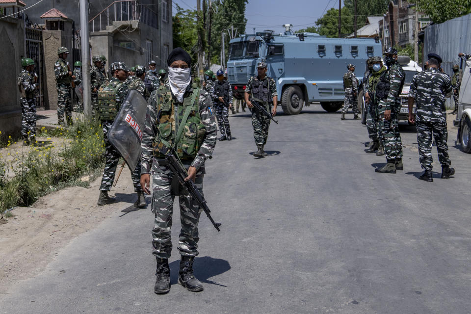 Paramilitary soldiers stand guard after dispersing Kashmiri Hindus, locally known as Pandits, during a protest march against the killing of Rahul Bhat, also a Pandit, on the outskirts of Srinagar, Indian controlled Kashmir, Friday, May 13, 2022. Hindus in Indian-controlled Kashmir staged protests on Friday a day after assailants shot and killed the government employee from the minority community. It was the first time that Pandits, an estimated 200,000 of whom fled Kashmir after an anti-India rebellion erupted in 1989, simultaneously organized street protests at several places in the Muslim-majority region. (AP Photo/Dar Yasin)