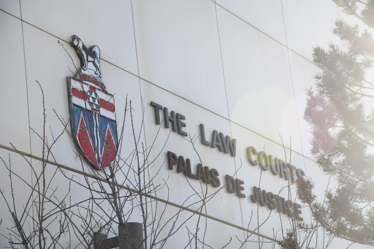 A close-up of the sign on the side of the courthouse in Whitehorse. Patrick Parker, 32, was found guilty in October for coercing a 15-year-old victim into a sexual act in exchange for crack cocaine. (Jackie Hong/CBC - image credit)