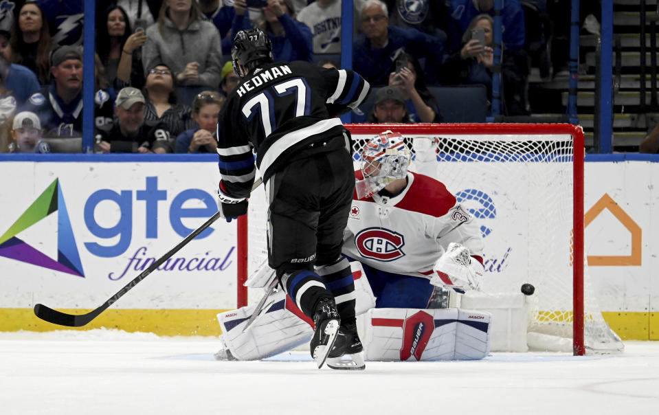 Tampa Bay Lightning defenseman Victor Hedman (77) scores on Montreal Canadiens goaltender Cayden Primeau (30) during the shootout of an NHL hockey game Saturday, March 2, 2024, in Tampa, Fla. (AP Photo/Jason Behnken)