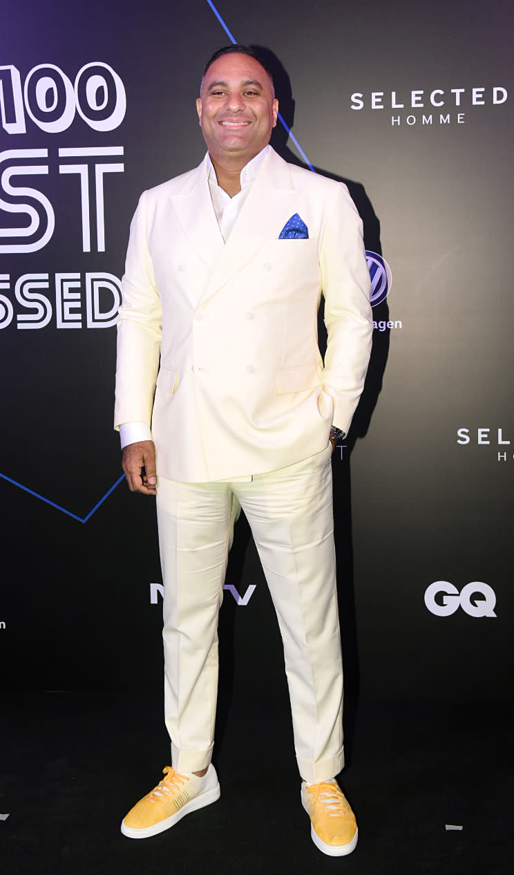 Comedian Russel Peters dressed in a stunning white suit.