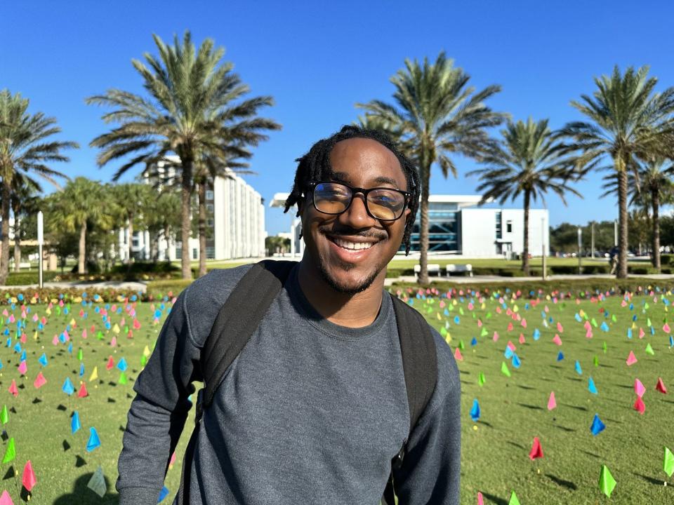 James Brown III, a junior at Embry-Riddle Aeronautical University, participated in "Field of Hope," a suicide-prevention event involving the posting of flags containing hopeful messages on Tuesday.