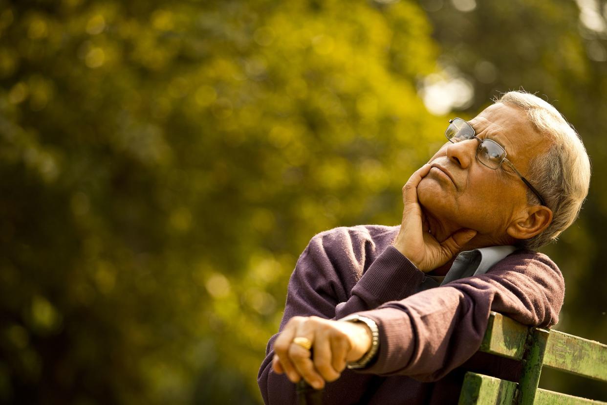 Thoughtful senior man sitting at park