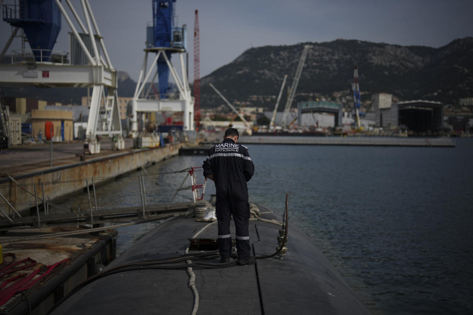 A sailor prepares a French Rubis-class submarine at the Toulon naval base in southern France, Monday, April 15, 2024. The nuclear powered submarine will be guarding France's Charles de Gaulle aircraft carrier during training exercises dubbed Neptune Strike in the Mediterranean with the 32-nation NATO military alliance. (AP Photo/Daniel Cole)