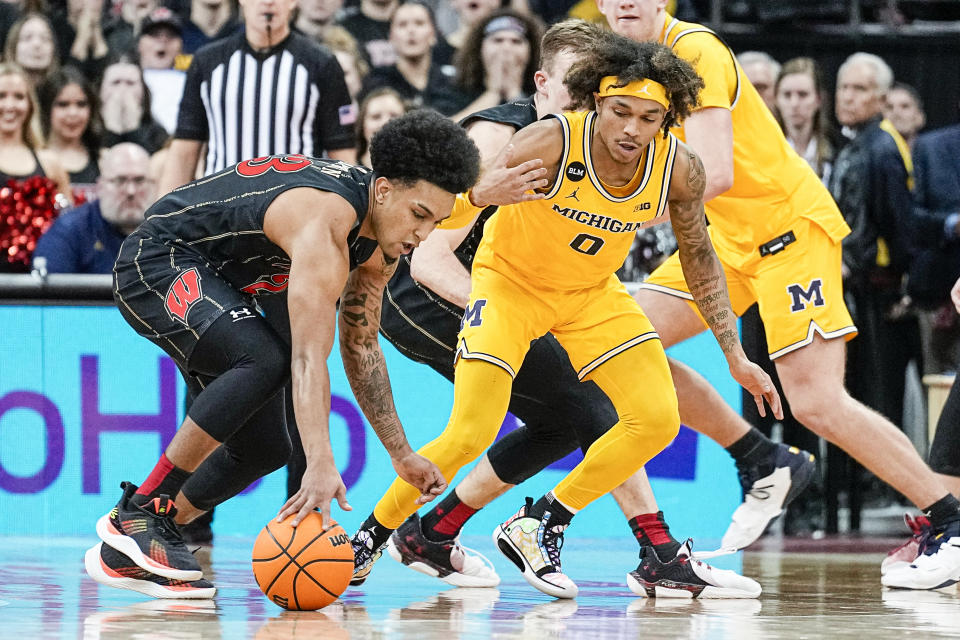 Wisconsin's Chucky Hepburn, left, steals the ball from Michigan's Dug McDaniel (0) on the final seconds of play in an NCAA college basketball game Tuesday, Feb. 14, 2023, in Madison, Wis. (AP Photo/Andy Manis)