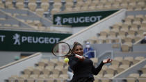 Serena Williams of the U.S. plays a shot against Kristie Ahn of the U.S. in a near-empty center court Philippe Chatrier in the first round match of the French Open tennis tournament at the Roland Garros stadium in Paris, France, Monday, Sept. 28, 2020. (AP Photo/Alessandra Tarantino)