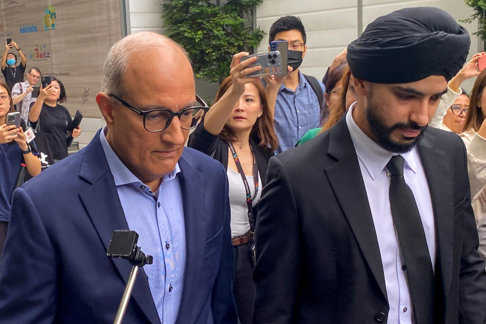 Singapore's former Minister for Transport and Minister-in-charge for Trade Relations S. Iswaran (left) leaves the State Court in Singapore on 18 January 2024.