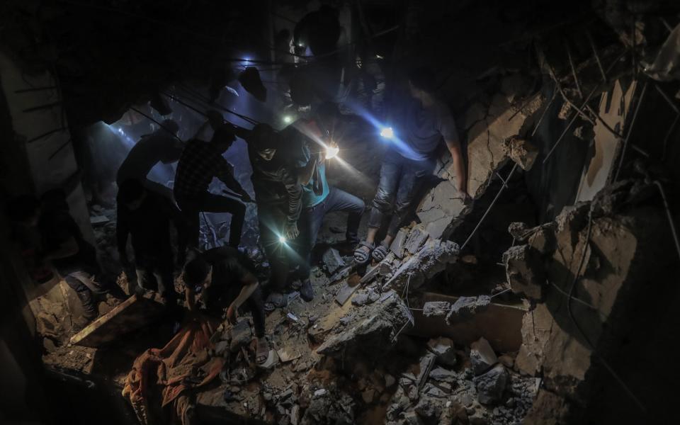 Locals carry out search and rescue efforts after an Israeli attack on Ridwan family house traps many Palestinians under rubble at Tel al-Sultan district of Rafah, Gaza