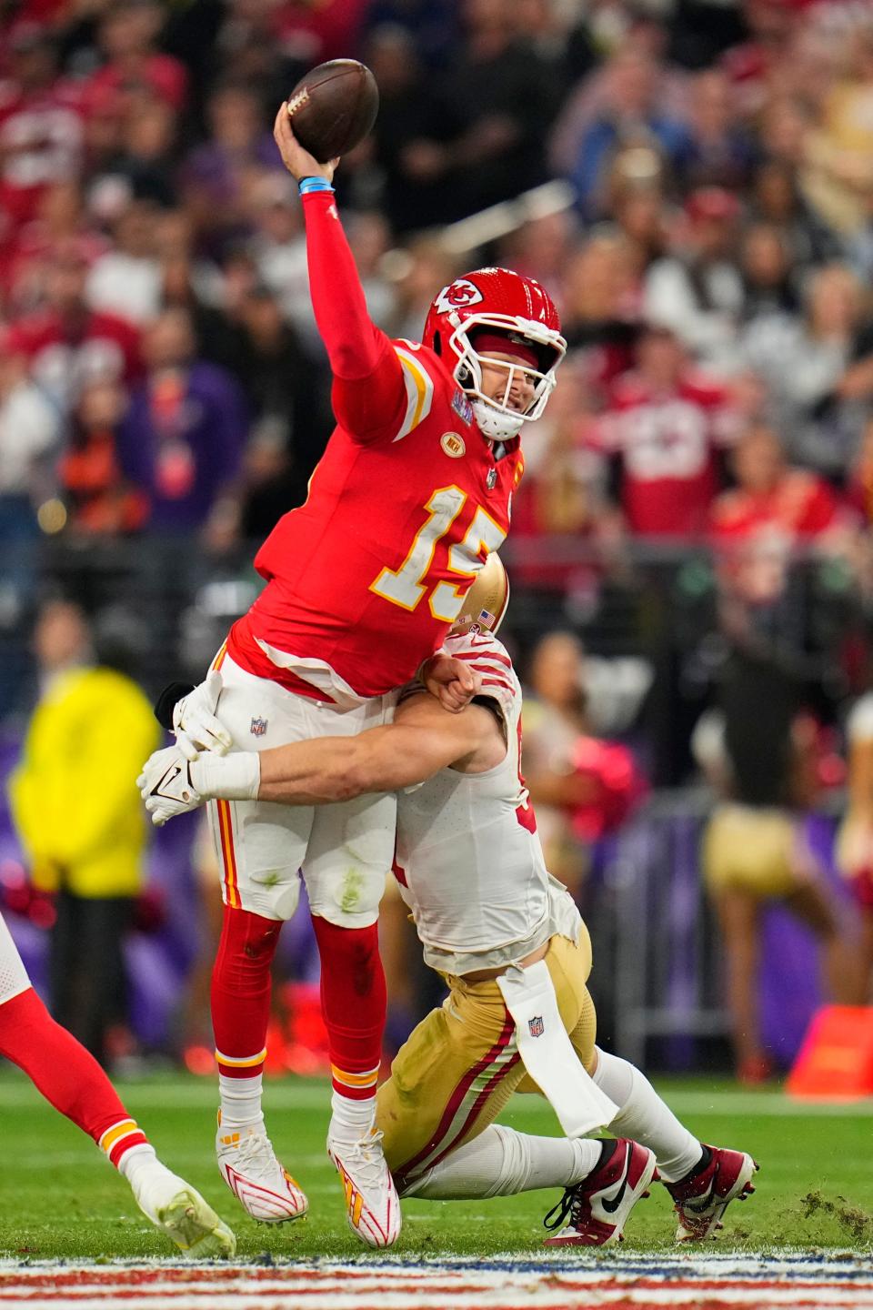 Chiefs quarterback Patrick Mahomes is hit as he throws by 49ers defensive end Nick Bosa during the second half of the Chiefs' 25-22 overtime win in Super Bowl 58 on Sunday, Feb. 11, 2024, in Las Vegas.