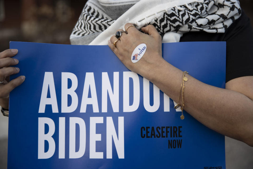 Farah Khan holds a sign near a voting site to encourage voters to vote "uncommitted" in Michigan Primary elections in Dearborn, Michigan, on February 27, 2024. (Photo by Mostafa Bassim/Anadolu via Getty Images)