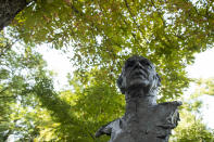 A statue bust of Spain's former monarch, King Juan Carlos I is pictured at the "Jardines del Campo del Moro" in Madrid, Spain, Monday, Aug. 3, 2020. Spain's royal family website on Monday Aug. 3, 2020, published a letter from Spain's former monarch, King Juan Carlos I, saying he is leaving Spain to live in another country, amidst a financial scandal. (AP Photo/Manu Fernandez)