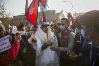 Nirmal Purja one of the team member of the all-Nepalese mountaineering team that became the first to scale Mount K2 in winter receives a scarf as they arrive at Tribhuwan International airport in Kathmandu, Nepal, Tuesday, Jan. 26, 2021. (AP Photo/Niranjan Shrestha)