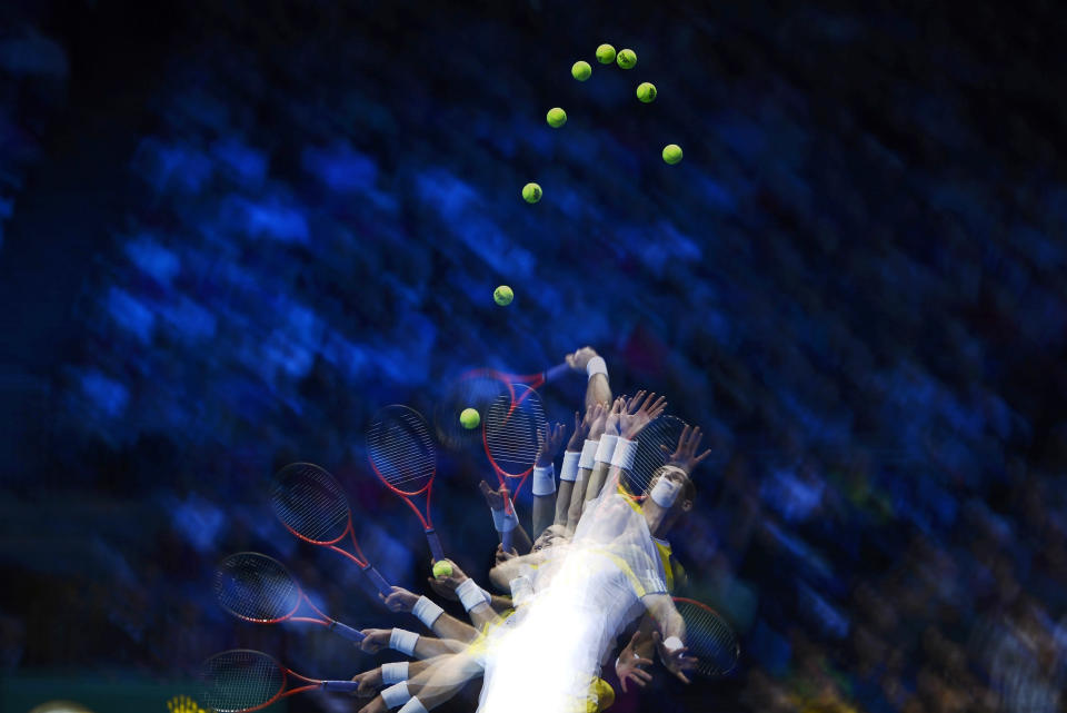 A multiple exposure photograph shows Britain's Andy Murray as he serves to Serbia's Novak Djokovic during their men's singles tennis match at the ATP World Tour Finals in the O2 Arena in London November 7, 2012. REUTERS/Dylan Martinez (BRITAIN - Tags: SPORT TENNIS)