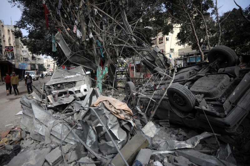 Torn cloths hang from tree branches above wrecked cars in the aftermath of Israeli bombing in Rafah in the southern Gaza Strip on Saturday as Israel announced the war had entered a 'new phase. Photo by Ismael Mohamad/UPI