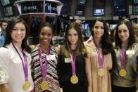 From left, Kyla Ross, Gabby Douglas, McKayla Maroney, Aly Raisman, and Jordyn Wieber, members of the United States women's Olympic gymnastics gold medal-winning team, pose for photos on the floor of the New York Stock Exchange, Tuesday, Aug. 14, 2012, in New York. (AP Photo/Alex Katz)