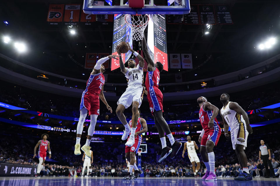 New Orleans Pelicans' Brandon Ingram, center, goes up for a shot against Philadelphia 76ers' Tobias Harris, left, and Mo Bamba during the first half of an NBA basketball game, Friday, March 8, 2024, in Philadelphia. (AP Photo/Matt Slocum)