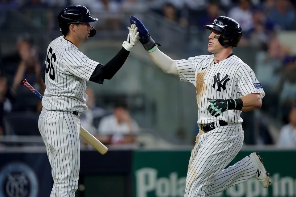Jul 26, 2023; Bronx, New York, USA; New York Yankees center fielder Harrison Bader (22) high fives catcher Kyle Higashioka (66) after scoring against the New York Mets on a single by shortstop Anthony Volpe (not pictured) during the fourth inning at Yankee Stadium. Mandatory Credit: Brad Penner-USA TODAY Sports