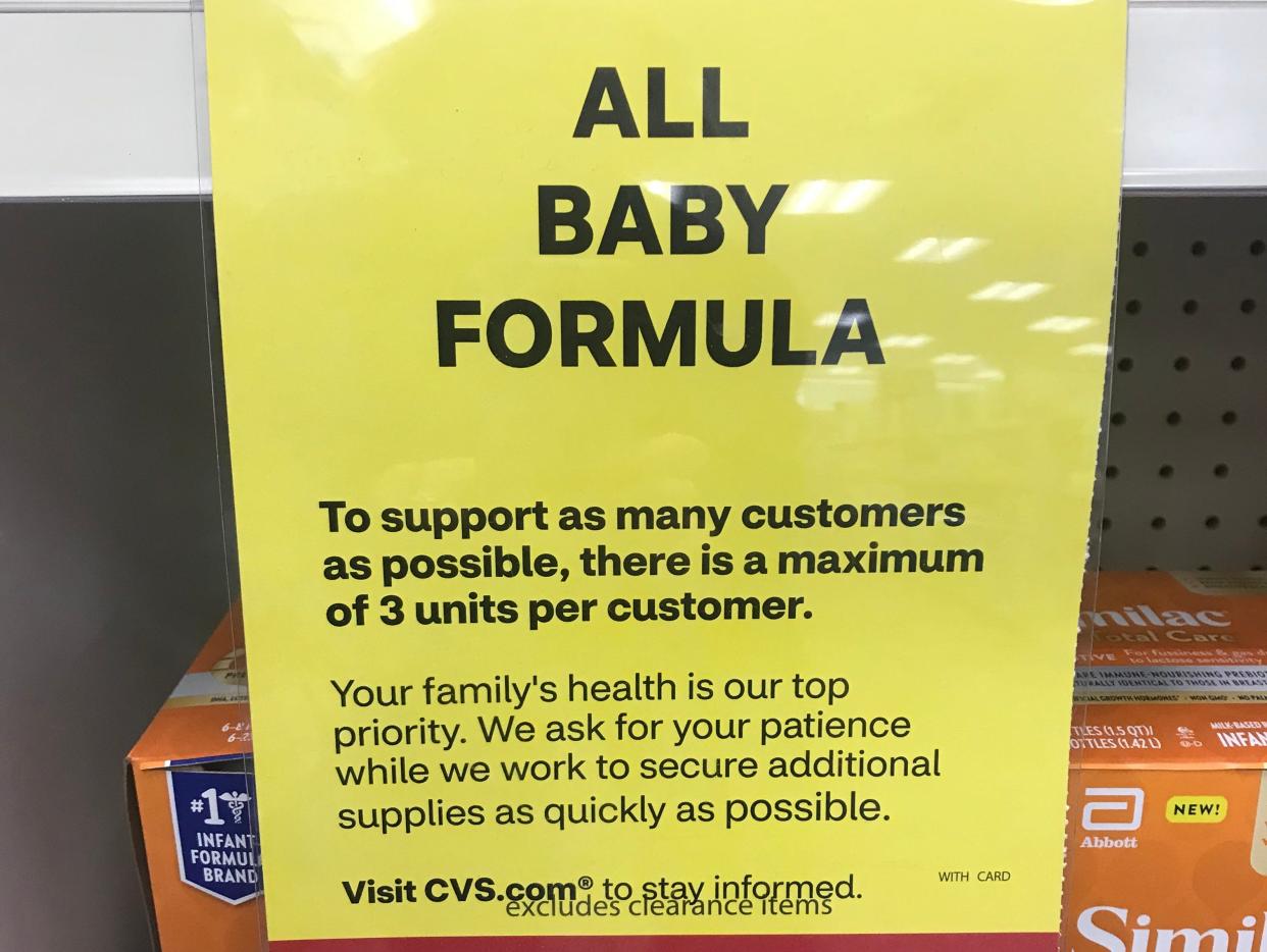 A sign attached to nearly bare shelves at drugstore chain CVS says customers are limited to three containers at a time.