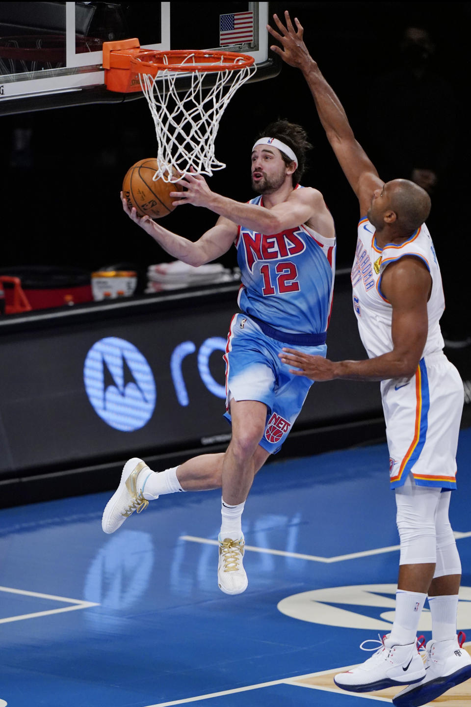 Oklahoma City Thunder center Al Horford, right, defends against Brooklyn Nets forward Joe Harris (12) as Harris goes up for a shot during the first quarter of an NBA basketball game Sunday, Jan. 10, 2021, in New York. (AP Photo/Kathy Willens)