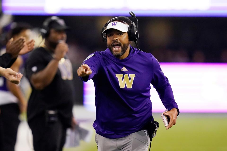 Washington coach Jimmy Lake yells toward the field during the first half of his team's game against California.