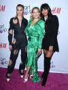 Model Cara Delevingne wears a cutout, denim jumpsuit by Guy Laroche, while US actress Kate Hudson wears a satin Michael Kors green dress and British star Jameela Jamil is in a black shirt, blazer and tie.<em> [Photo: Getty]</em>