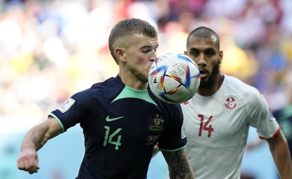 Australia's Riley McGree and Tunisia's Aissa Laidouni challenge for the ball during the World Cup group D soccer match between Tunisia and Australia at the Al Janoub Stadium in Al Wakrah, Qatar, Saturday, Nov. 26, 2022. (AP Photo/Luca Bruno)