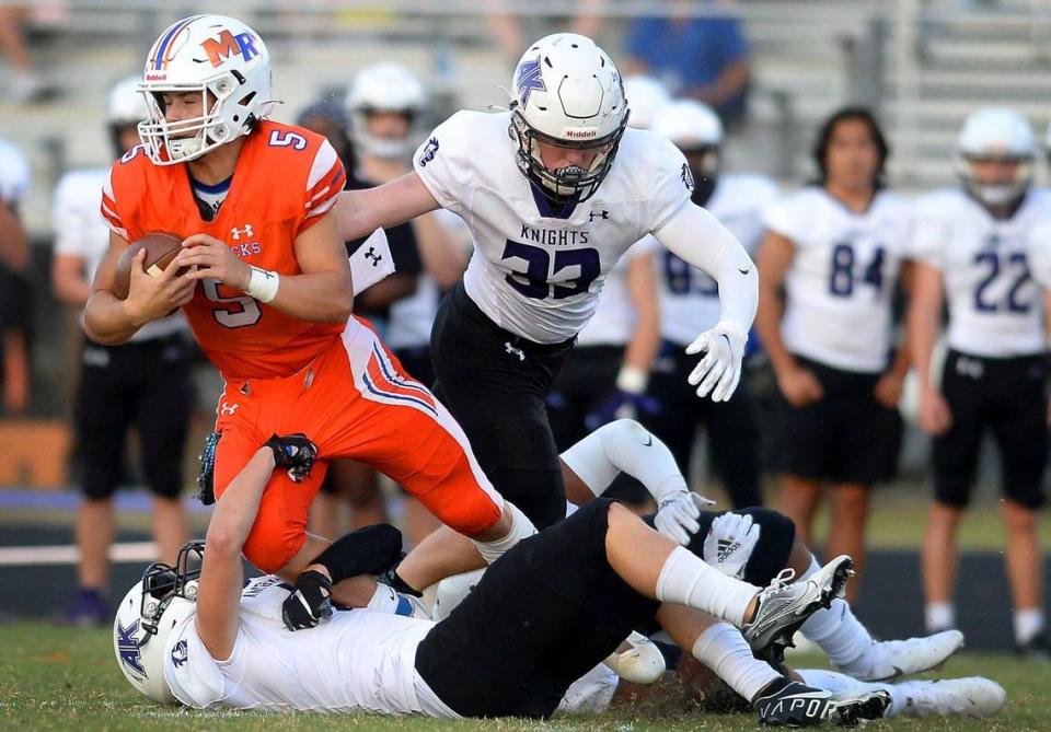 Ardrey Kell defenders swarm Marvin Ridge quarterback Evan Medders, left, during first half action on Friday, September 3, 2021.