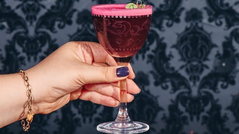 hand holding cocktail goblet