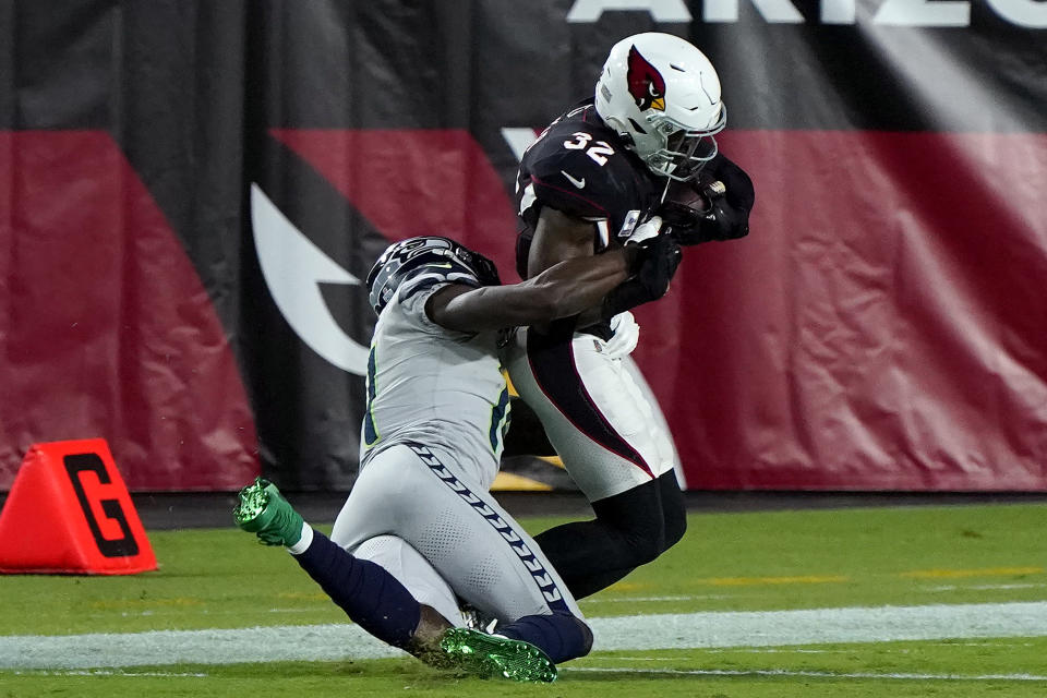 Seattle Seahawks wide receiver DK Metcalf tackles Arizona Cardinals strong safety Budda Baker (32) short of the goal line after Baker intercepted a pass during the first half of an NFL football game, Sunday, Oct. 25, 2020, in Glendale, Ariz. (AP Photo/Rick Scuteri)