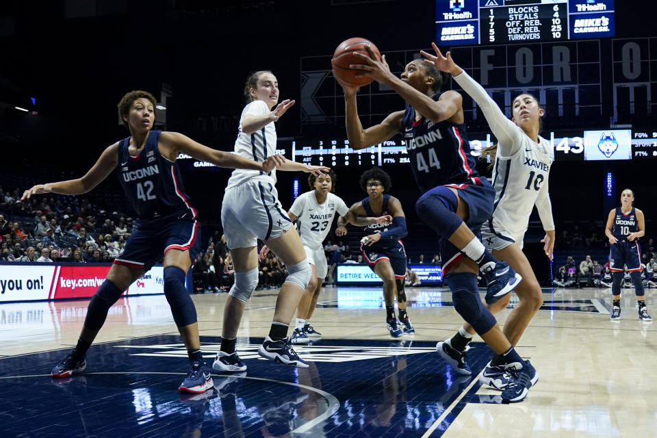 UConn forward Aubrey Griffin (44) drives against Xavier's Fernanda Ovalle (10) during the first half of an NCAA college basketball game, Thursday, Jan. 5, 2023, in Cincinnati. (AP Photo/Jeff Dean)