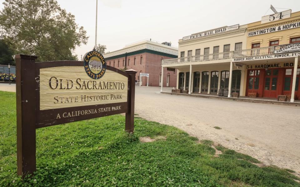 A wooden sign marks Old Sacramento State Historical Park via Getty Images