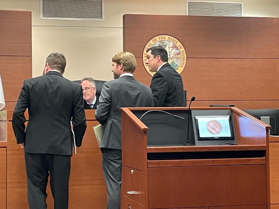 Lawyers from both sides talking with the judge