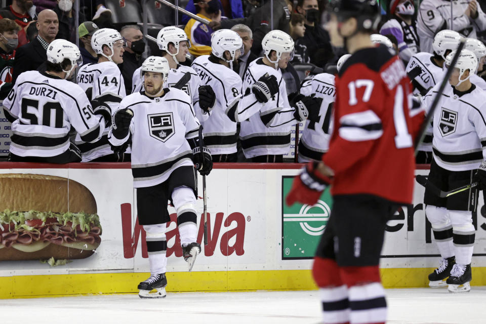 Los Angeles Kings left wing Viktor Arvidsson (33) celebrates with teammates after scoring a goal during the second period of an NHL hockey game against the New Jersey Devils, Sunday, Jan. 23, 2022, in Newark, N.J. (AP Photo/Adam Hunger)