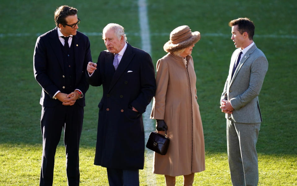 Ryan Reynolds, King Charles III, the Queen Consort, and Rob McElhenney at the Wrexham Association Football Club's Racecourse Ground. (Jacob King / Getty Images)