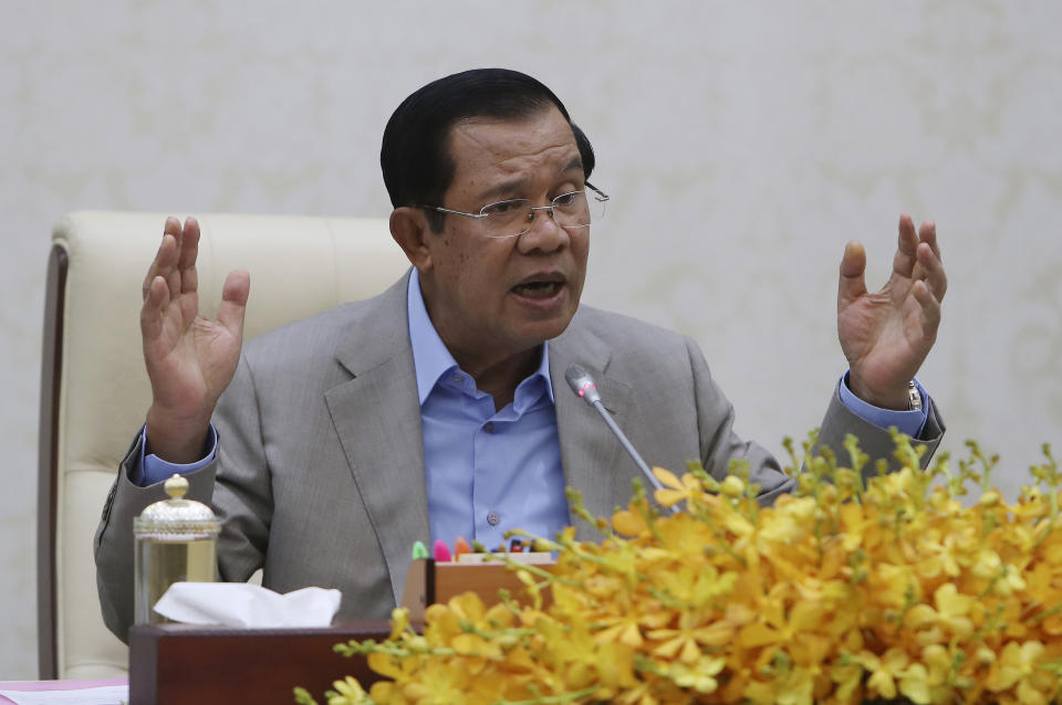 Cambodia's Prime Minister Hun Sen gestures during a speech on the current state of a new virus from China in Phnom Penh, Cambodia, Thursday, Jan. 30, 2020. Cambodia's leader has urged citizens to remain calm about the new virus from China, which has been confirmed in a single case of a visitor from Wuhan. (AP Photo/Heng Sinith)