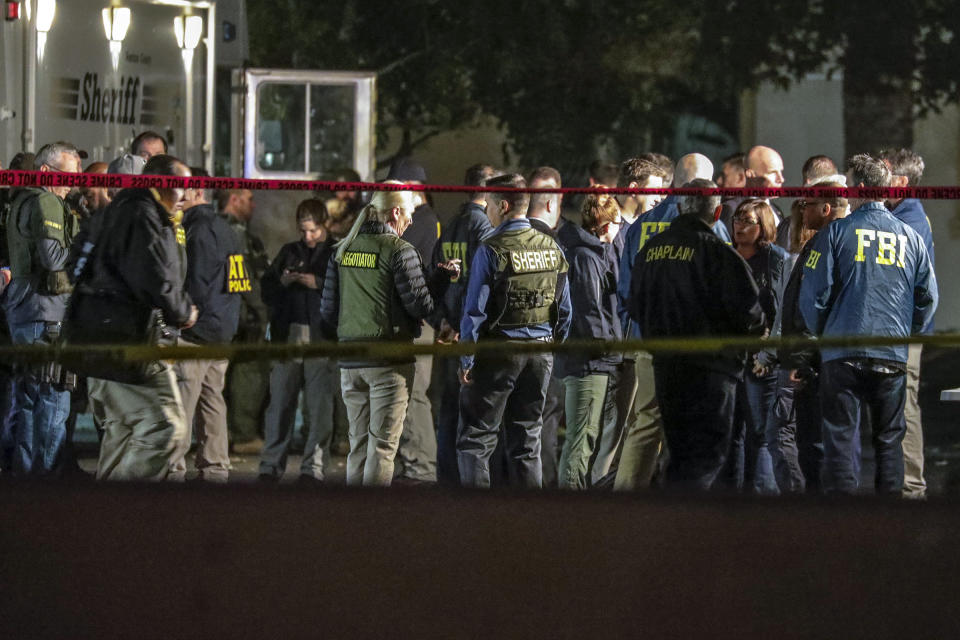 Sheriff and FBI investigators huddle at the command post.