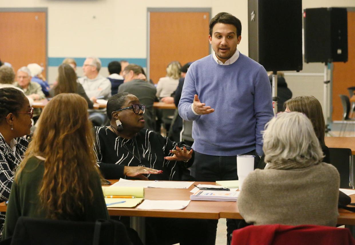 Akron Councilwoman Linda Omobien listens as Mayor Shammas Malik answers a question March 20 during a town hall meeting at Firestone Community Learning Center.