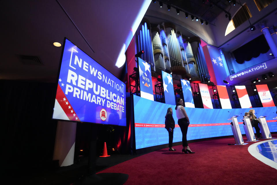 Stand-ins assume positions of candidates and moderators to check sound and lighting, in advance of a Republican presidential primary debate hosted by NewsNation on Wednesday, Dec. 6, 2023, at the Moody Music Hall at the University of Alabama in Tuscaloosa, Ala. (AP Photo/Gerald Herbert)