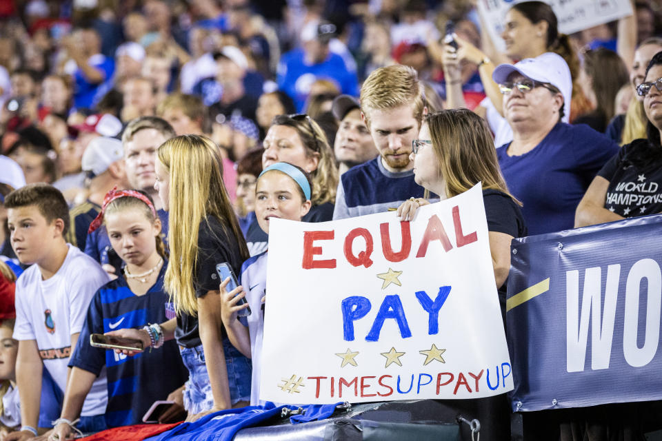 HARRISON, NJ - MARCH 08: A fan holds up a sign that says "Equal Pay Times Up Pay Up" in support of the United States Women's National Team fight for equal pay. This was during the 2020 SheBelieves Cup match between United States and Spain sponsored by Visa.  The match took place at Red Bull Arena on March 08, 2020 in Harrison, NJ, USA.  The United States won by a score of 1 to 0. On May 1, 2020, a Federal Judge dismissed the equal pay claims of the World Cup Champions. (Photo by Ira L. Black/Corbis via Getty Images)