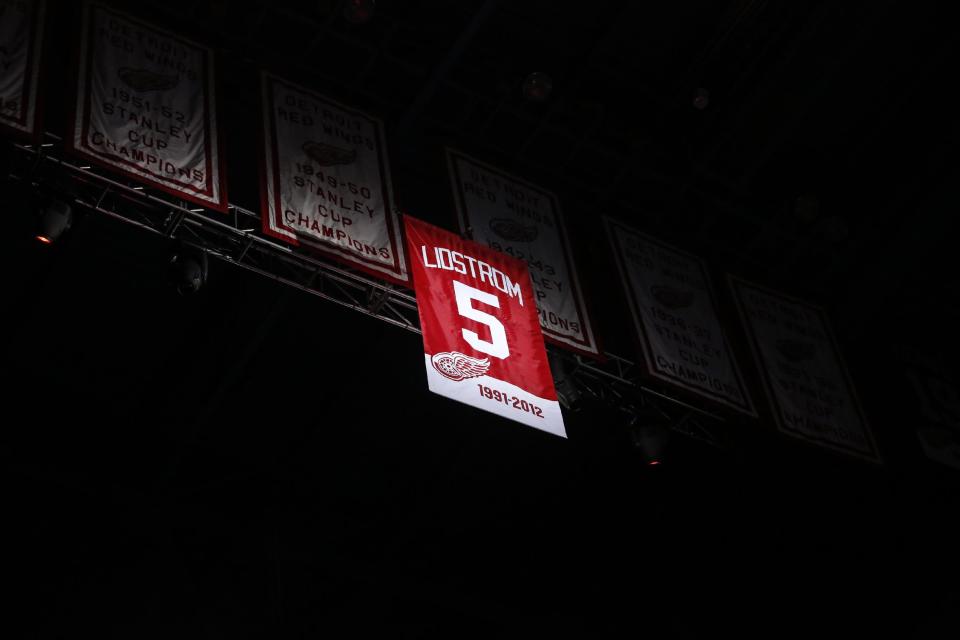 Former Detroit Red Wing Nicklas Lidstrom's No. 5 banner is raised to the rafter during the retirement of the number before an NHL hockey game between the Detroit Red Wings and Colorado Avalanche at Joe Louis Arena, Thursday, March 6, 2014, in Detroit. (AP Photo/Duane Burleson)