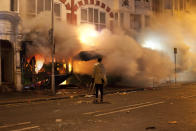 Smoke plumes from a Croydon shop on Monday as it was engulfed in flames from an arson attack.