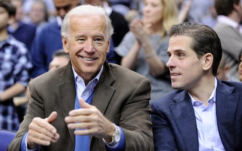 Joe Biden and his son Hunter at a basketball game in 2010 - Credit: AP Photo/Nick Wass