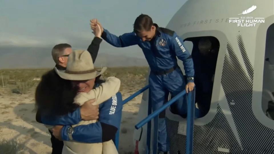 Jeff Bezos and his brother Mark high-five and hug on landing from the first crewed Blue Origin spaceflight in July 2021. Amazon stock dipped before this, as investors feared he wouldn’t return safely (Blue origin / Unpixs Europe)