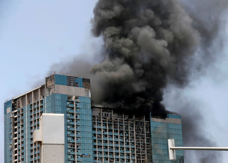 Smoke rises after a fire broke out in a building in Abu Dhabi, UAE, August 30, 2016. REUTERS/Stringer