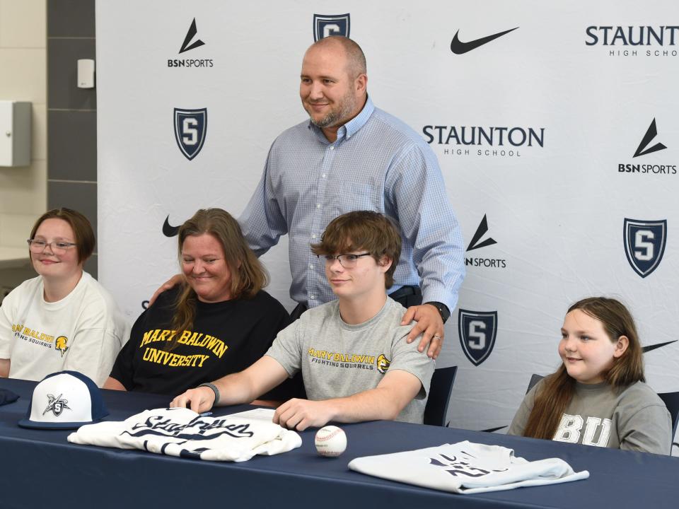 George Laase, standing, will step down as head baseball coach at Staunton High School. Here is stands behind  Logan Hicks and his family May 19 as the Staunton player celebrated committing to Mary Baldwin University to play baseball.