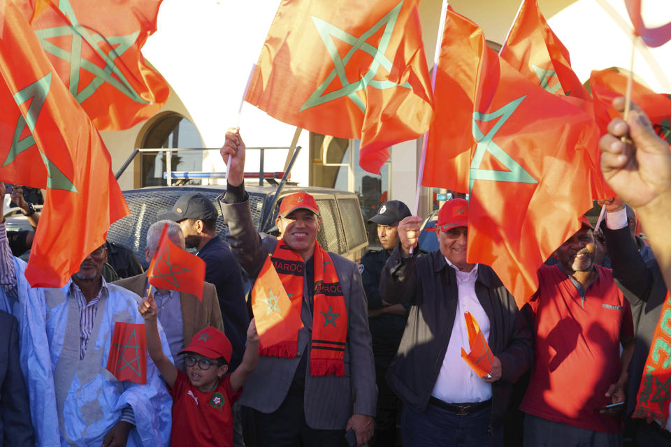 Moroccans celebrate their World Cup victory against Portugal in the Morocco-administered Western Sahara city of Laayoune, Saturday, Dec. 10, 2022. (AP Photo/Noureddine Abakchou)