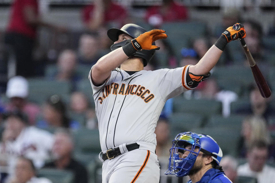 San Francisco Giants' J.D. Davis watches his RBI sacrifice fly against the Atlanta Braves during the fourth inning of a baseball game Saturday, Aug. 19, 2023, in Atlanta. (AP Photo/John Bazemore)