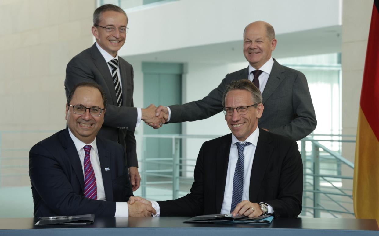 Pat Gelsinger and Olaf Scholz (rear) shaking hands last year as Intel agreed the biggest ever foreign investment in Germany