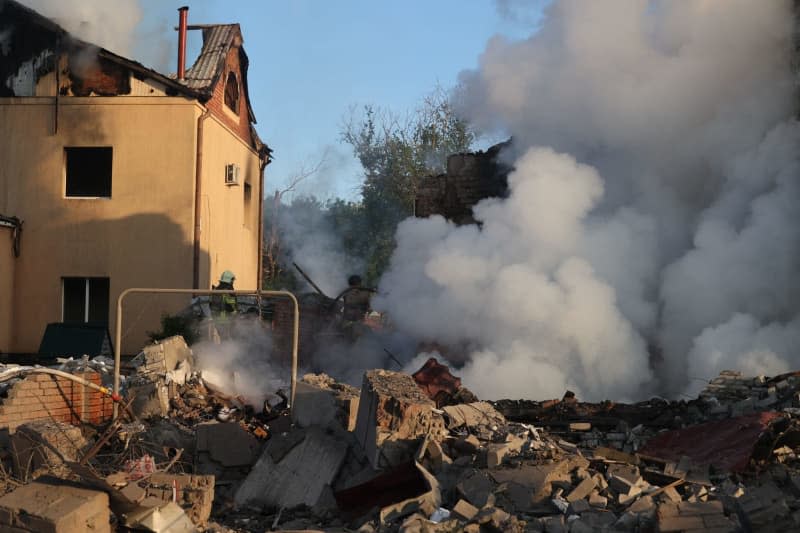 Firefighters extinguish a house after a Russian missile attack on Kharkiv, northeastern Ukraine. -/Ukrinform/dpa