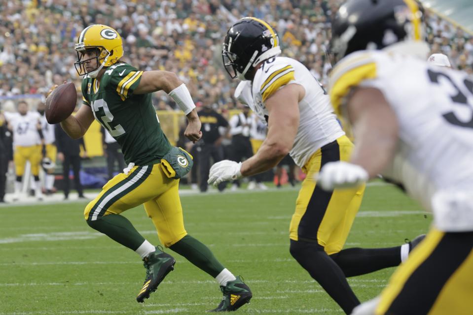 Green Bay Packers' Aaron Rodgers runs for a touchdown during the first half of an NFL football game against the Pittsburgh Steelers Sunday, Oct. 3, 2021, in Green Bay, Wis. (AP Photo/Mike Roemer)