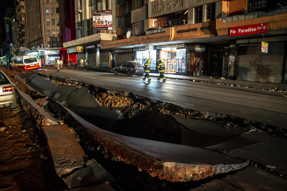 Emergency services gather at the scene of a gas explosion downtown Johannesburg, South Africa, Wednesday July 19, 2023. Search and rescue officials also ordered residents in nearby buildings to evacuate the area and the area where the explosion happened was cordoned off. (AP Photo/Shiraaz Mohamed)